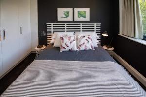 Fresh cushions, dark walls Design ideas for an eclectic master bedroom in Sydney with grey walls.
