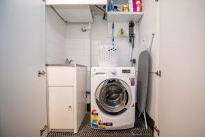 Laundry set up for short term rental Eclectic laundry room in Sydney.
