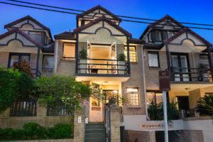 Inspiration for a mid-sized contemporary two-storey brick beige apartment exterior in Sydney with a gable roof and a tile roof.
