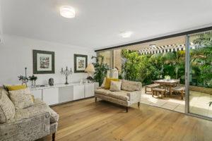 Mid-sized contemporary formal open concept living room in Sydney with white walls, light hardwood floors and no fireplace.