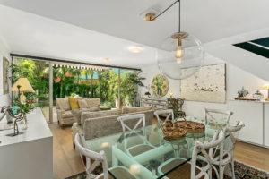 Design ideas for a mid-sized beach style open plan dining in Sydney with white walls, light hardwood floors and no fireplace.