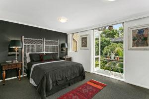 Design ideas for a mid-sized asian master bedroom in Sydney with white walls, carpet, no fireplace and grey floor.