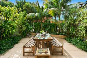 Photo of a mid-sized contemporary backyard partial sun formal garden in Sydney with concrete pavers.