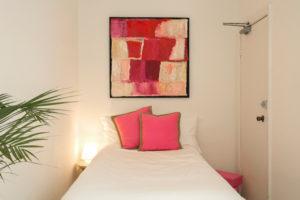 Small contemporary bedroom in Sydney with white walls and no fireplace.