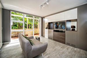 Inspiration for a small contemporary open concept living room in Sydney with grey walls, light hardwood floors, no fireplace and a freestanding tv.