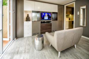 Design ideas for a small contemporary open concept living room in Sydney with grey walls, light hardwood floors, no fireplace and a freestanding tv.