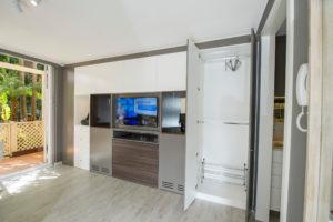 Photo of a small contemporary open concept living room in Sydney with grey walls, light hardwood floors, no fireplace and a freestanding tv.