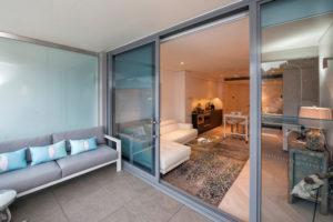 This is an example of a small contemporary balcony in Sydney with a roof extension.